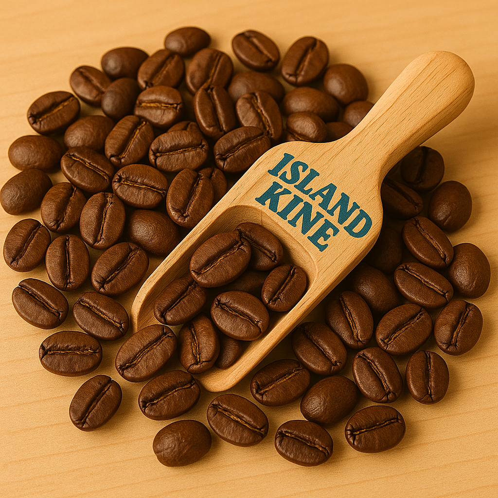 Close-up of roasted coffee beans with a wooden scoop labeled Island Kine on a light wooden surface